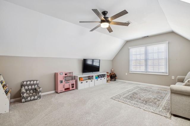 playroom with lofted ceiling, light carpet, baseboards, and a ceiling fan