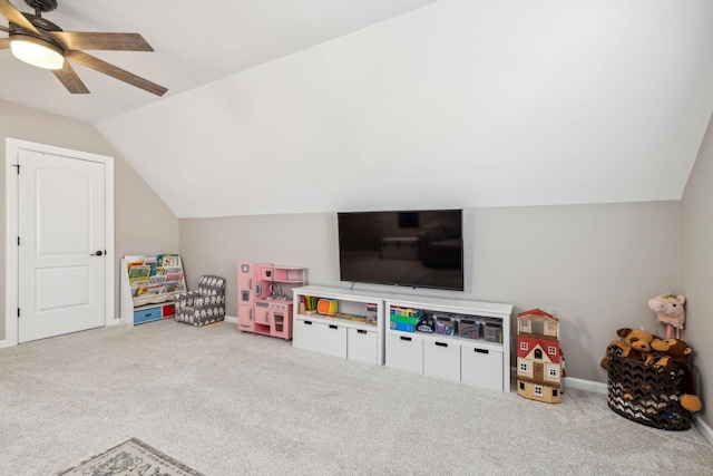 playroom with ceiling fan, carpet, baseboards, and vaulted ceiling