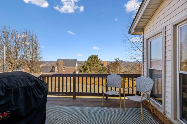 wooden terrace with area for grilling