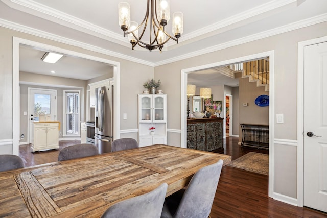 dining area featuring baseboards, crown molding, dark wood finished floors, and a notable chandelier