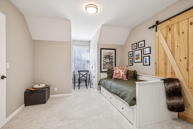 bedroom with lofted ceiling, a barn door, baseboards, and light colored carpet