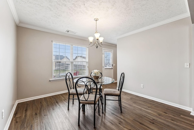 dining space featuring dark wood-style floors, baseboards, a notable chandelier, and ornamental molding