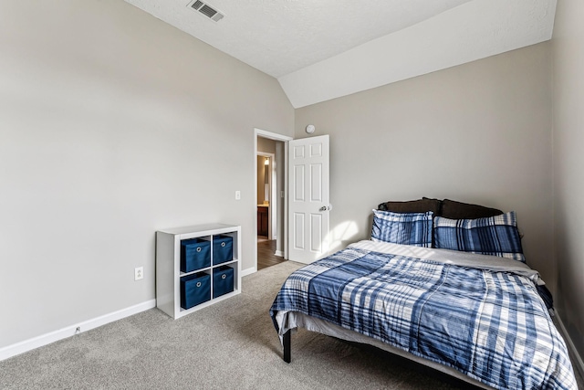 carpeted bedroom featuring baseboards, visible vents, and vaulted ceiling