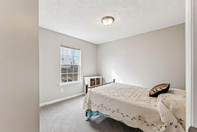 bedroom featuring a textured ceiling, baseboards, and carpet flooring