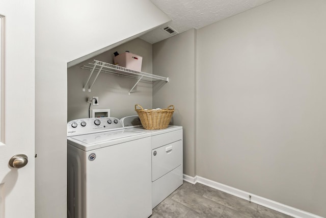 laundry area featuring visible vents, a textured ceiling, laundry area, independent washer and dryer, and baseboards