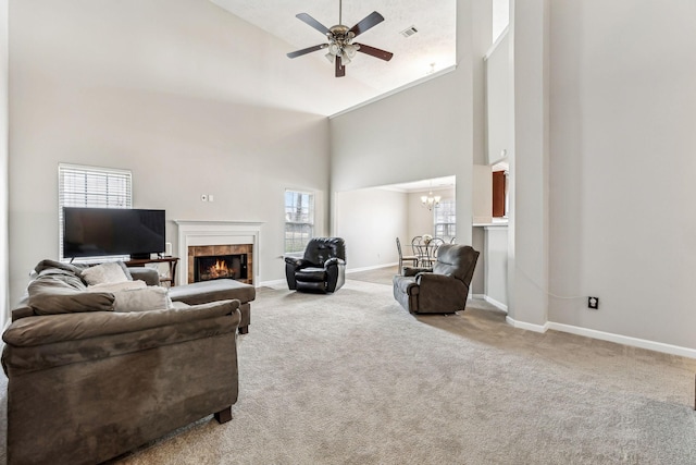 living area with high vaulted ceiling, carpet flooring, visible vents, and a tiled fireplace