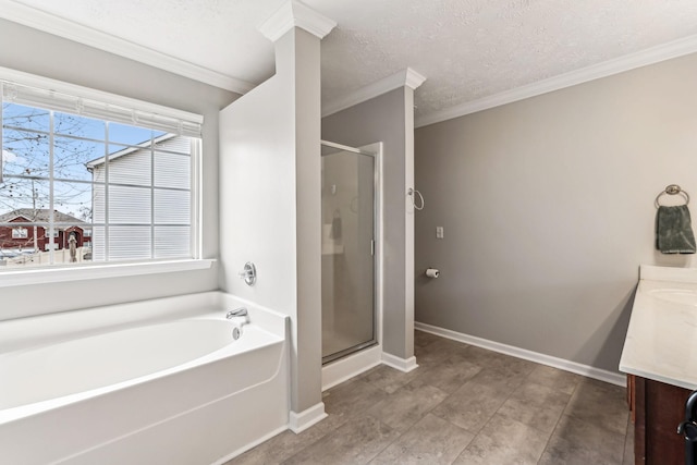 full bathroom with a stall shower, vanity, baseboards, and a bath