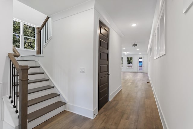 hallway featuring stairs, dark wood-style flooring, recessed lighting, and baseboards