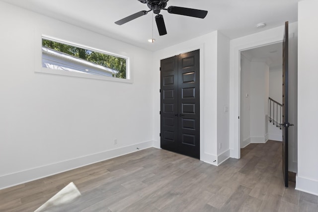 bedroom featuring baseboards, ceiling fan, and light wood finished floors