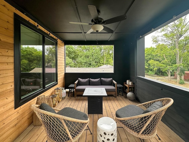 wooden deck with ceiling fan and an outdoor hangout area