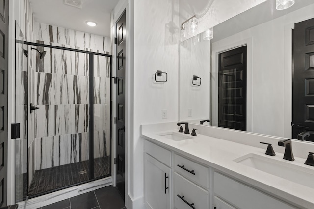 full bathroom featuring double vanity, tile patterned floors, a sink, and a shower stall