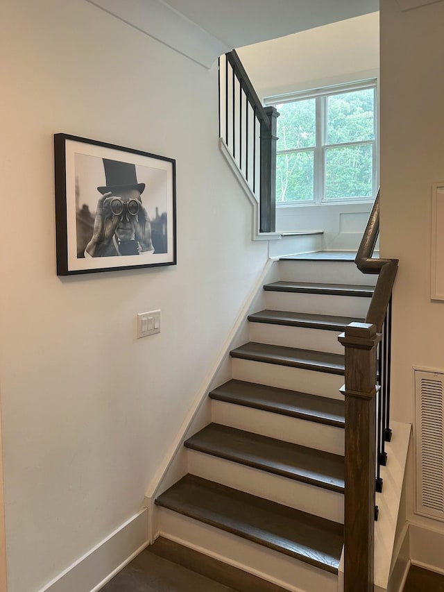 staircase featuring visible vents and baseboards