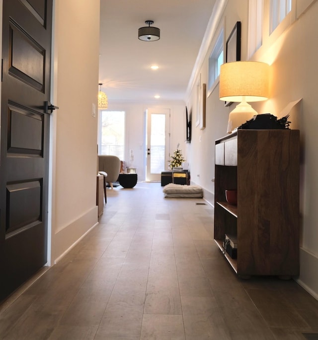 corridor featuring recessed lighting and baseboards