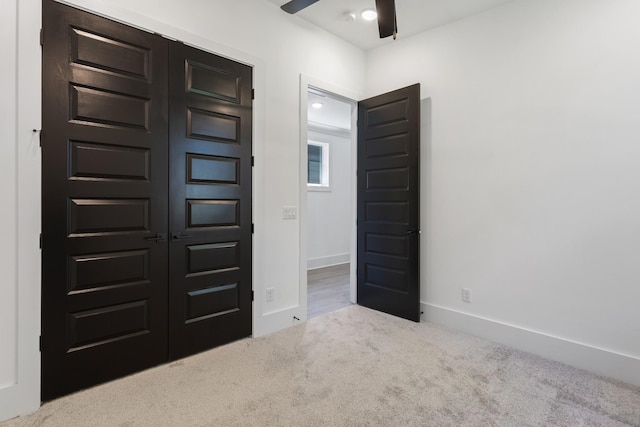 unfurnished bedroom with light carpet and baseboards