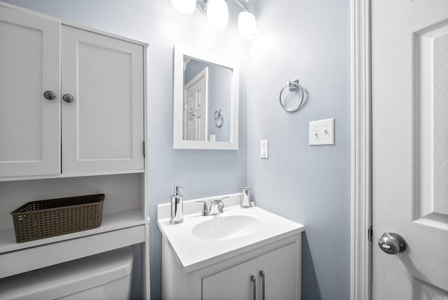 bathroom with toilet and vanity