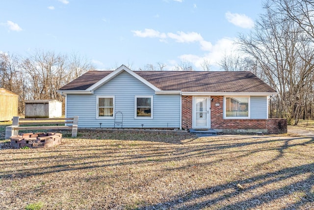 ranch-style home with a front yard and brick siding