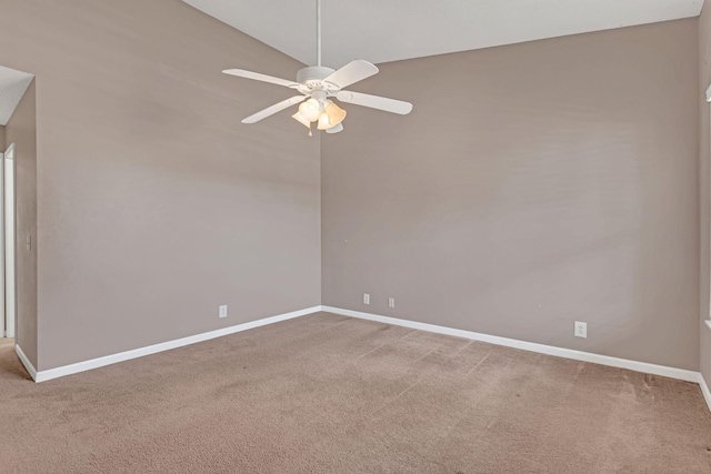 carpeted empty room featuring lofted ceiling, a ceiling fan, and baseboards