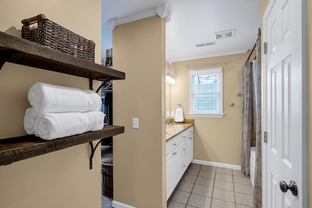 bathroom featuring shower / tub combo with curtain, ornamental molding, vanity, tile patterned flooring, and baseboards