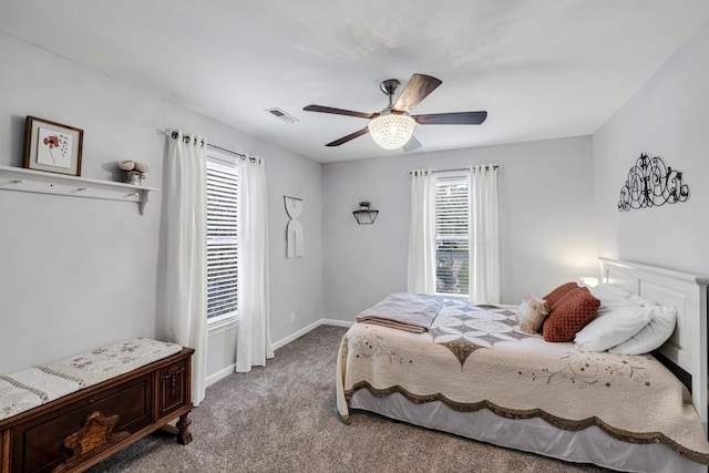 bedroom with multiple windows, carpet, visible vents, and baseboards