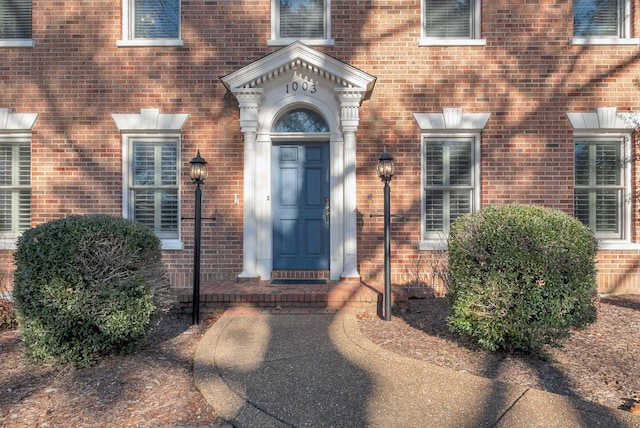 property entrance featuring brick siding