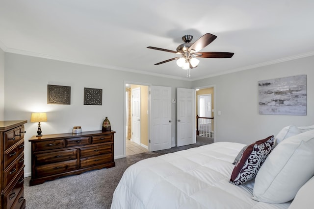 bedroom featuring light carpet, baseboards, a ceiling fan, ornamental molding, and ensuite bathroom