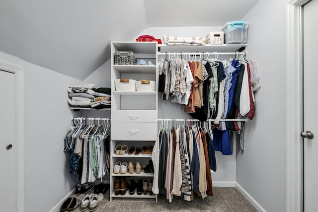 spacious closet featuring carpet flooring and vaulted ceiling