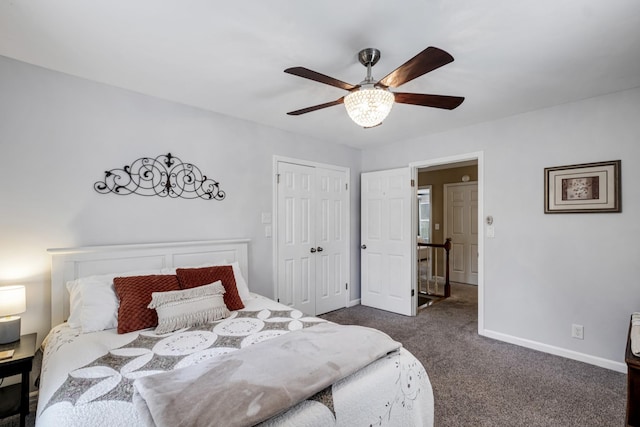 bedroom with a ceiling fan, a closet, dark carpet, and baseboards