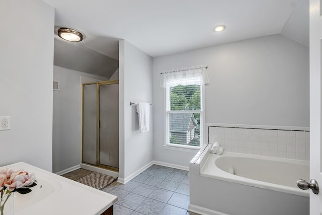 bathroom featuring lofted ceiling, tile patterned floors, vanity, and baseboards