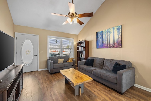 living area with high vaulted ceiling, wood finished floors, a ceiling fan, and baseboards