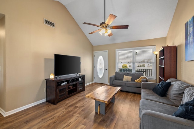 living room featuring high vaulted ceiling, baseboards, visible vents, and wood finished floors