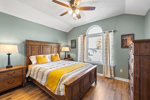 bedroom with lofted ceiling, ceiling fan, baseboards, and wood finished floors