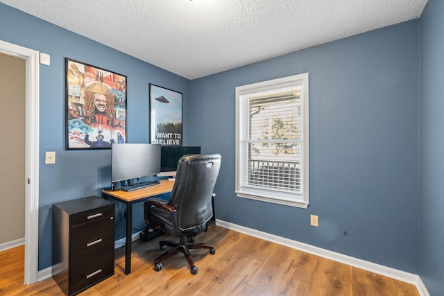 office area featuring a textured ceiling, wood finished floors, and baseboards