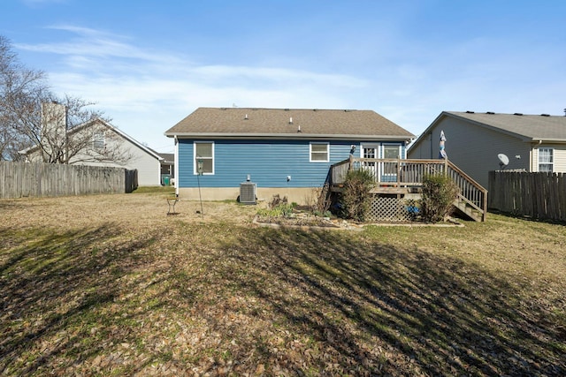 back of house with a deck, central air condition unit, fence, stairway, and a lawn