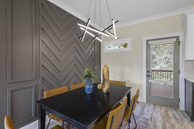 dining space featuring ornamental molding and light wood-type flooring