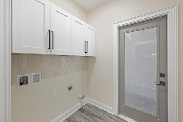 laundry area featuring washer hookup, baseboards, cabinet space, light wood finished floors, and electric dryer hookup