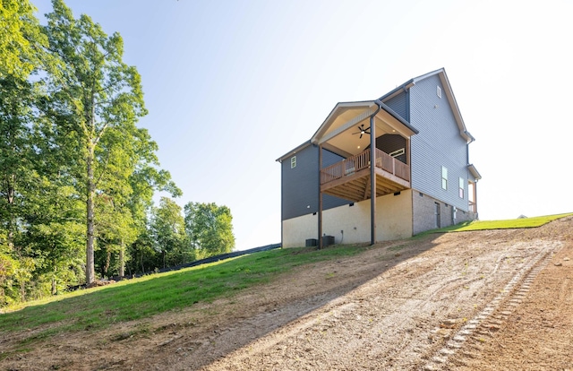 rear view of property with a ceiling fan