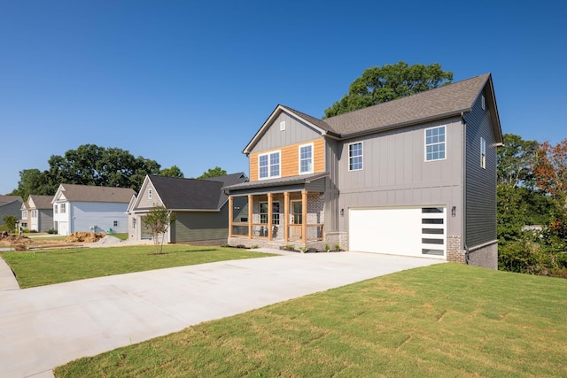 view of front of property with a garage, driveway, a porch, board and batten siding, and a front yard