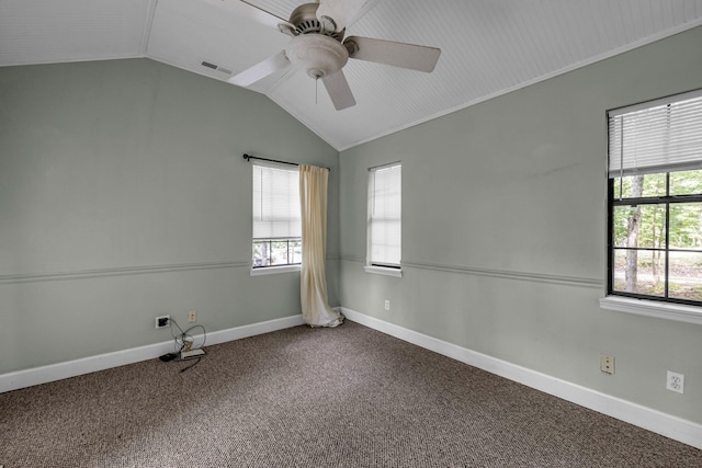 carpeted spare room with lofted ceiling, ceiling fan, visible vents, and baseboards