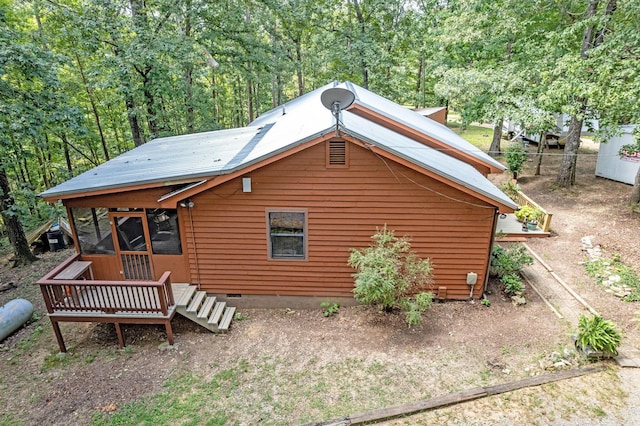 view of front of home featuring crawl space and fence