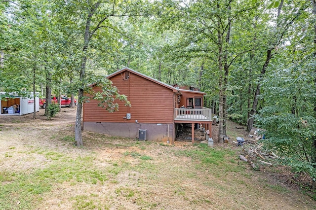 view of home's exterior with crawl space, a yard, and a wooden deck