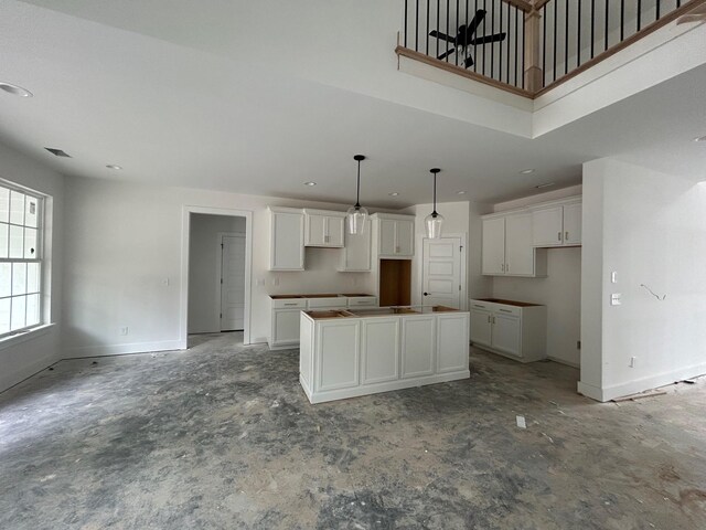 1136 Bermuda Chase St, Smyrna, TN 37167 - kitchen with white cabinetry, a kitchen island, baseboards, recessed lighting, and pendant lighting