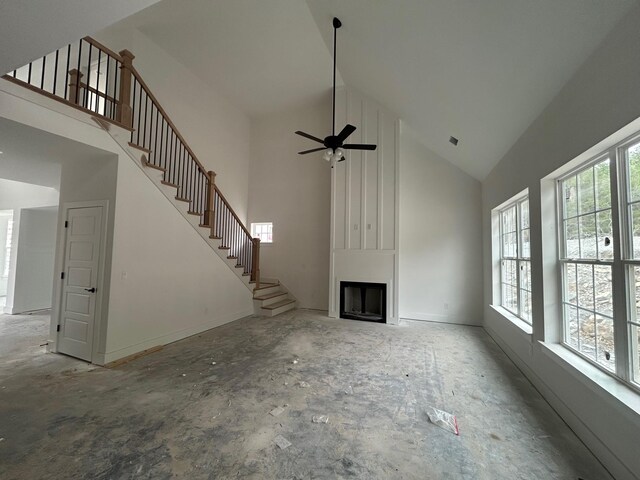 1136 Bermuda Chase St, Smyrna, TN 37167 - unfurnished living room with high vaulted ceiling, a fireplace, ceiling fan, and stairway