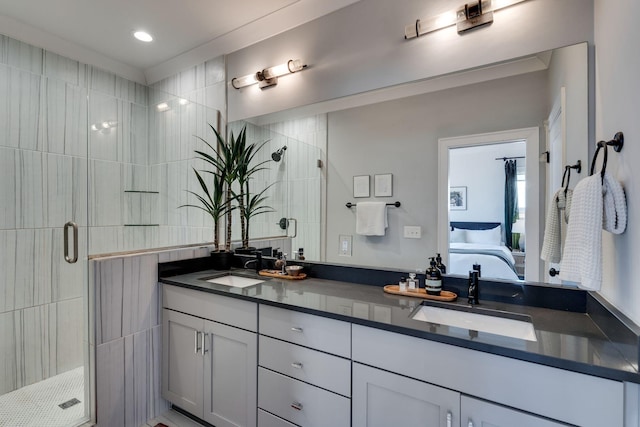 bathroom featuring a sink, a shower stall, ensuite bath, and double vanity