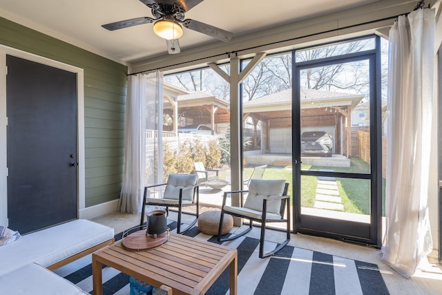 sunroom featuring a ceiling fan