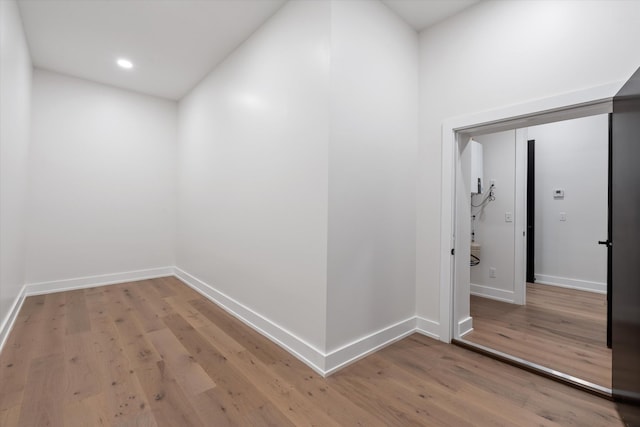 hallway with wood finished floors and baseboards