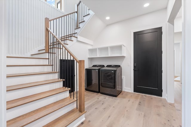 laundry room with laundry area, light wood-style flooring, washer and dryer, and recessed lighting