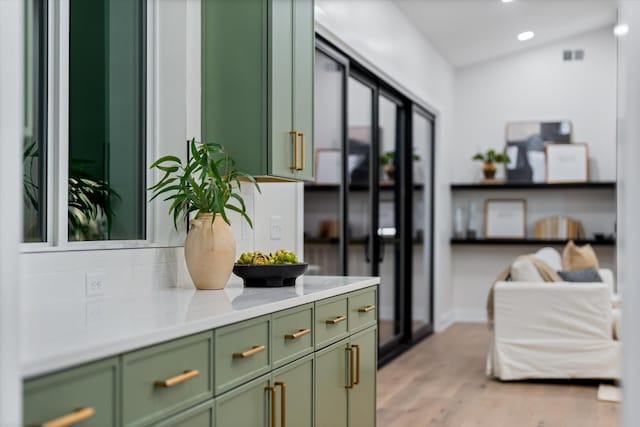 interior space featuring lofted ceiling, light wood finished floors, and recessed lighting