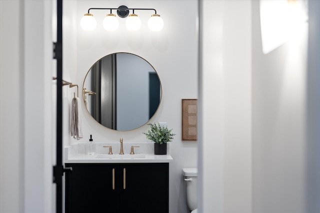 bathroom featuring toilet and vanity