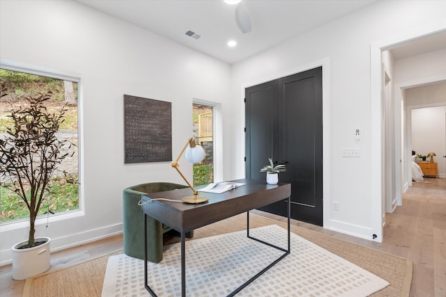 home office featuring recessed lighting, a ceiling fan, baseboards, visible vents, and light wood-style floors