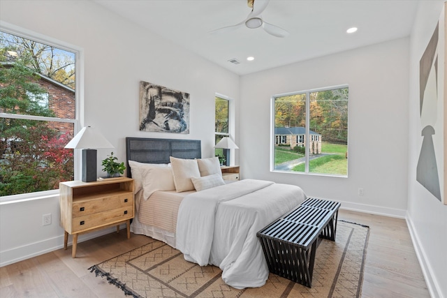 bedroom featuring recessed lighting, visible vents, light wood-style floors, a ceiling fan, and baseboards